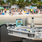 Patio table with drink holders on a boat, beach in the background