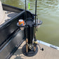 Soda can in a 2 pc cup holder, fishing rod holder caddy near a water body.