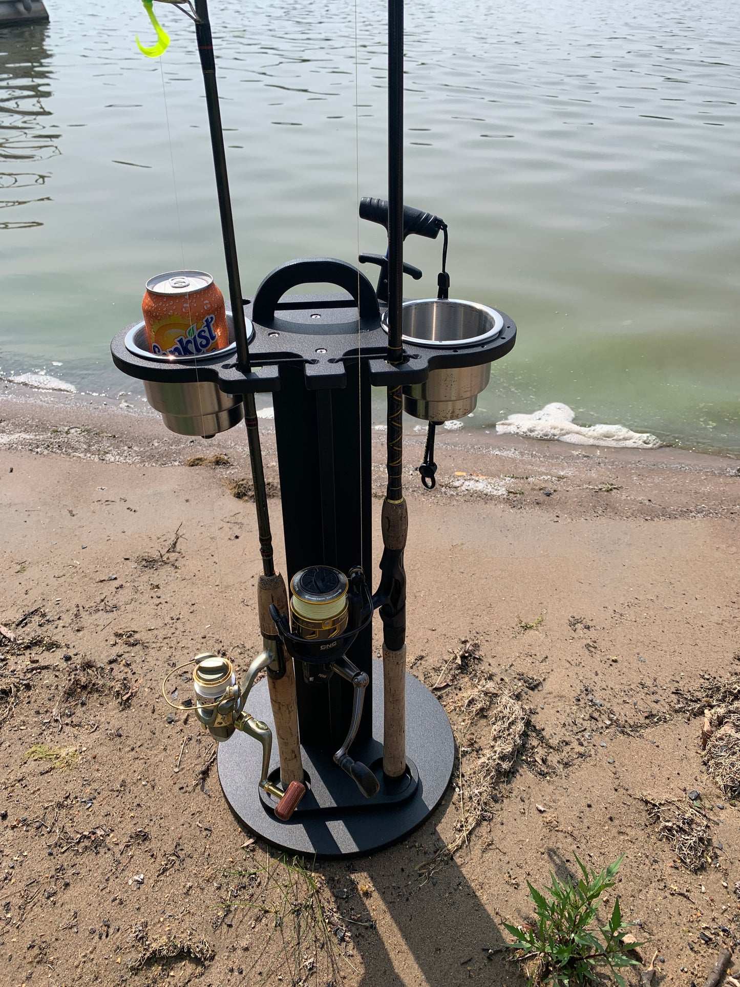 Soda can in a 2 pc cup holder, fishing rod holder caddy on a beach