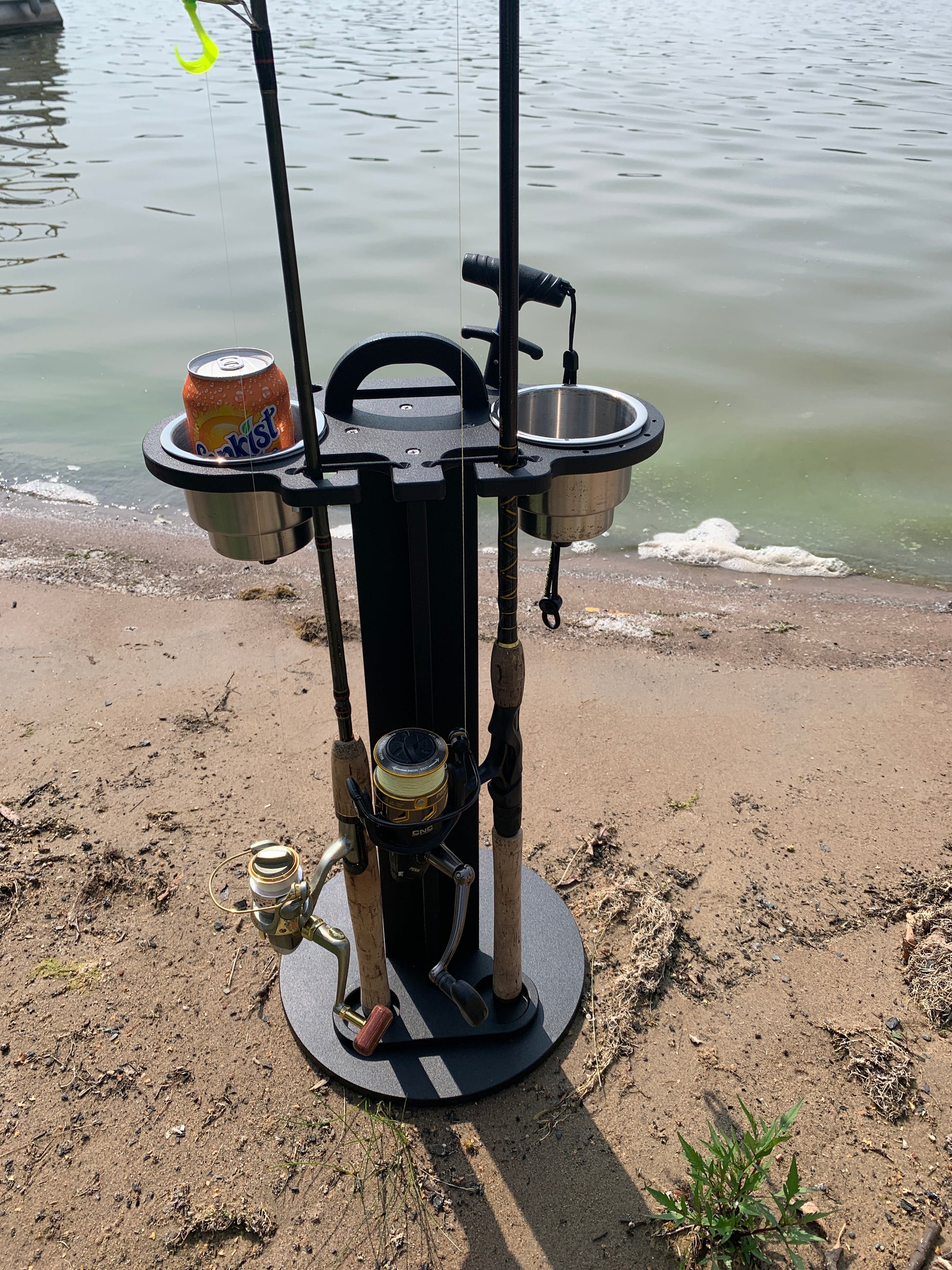 Soda can in a 2 pc cup holder, fishing rod holder caddy on a beach